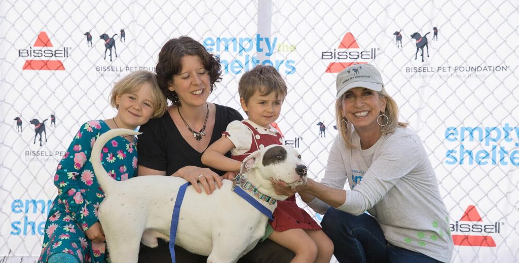 Cathy Bissell and a family with dog